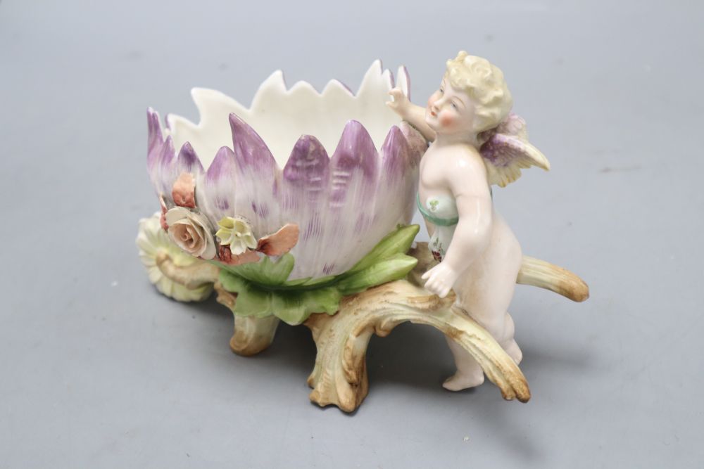 A pair of Augustus Rex floral encrusted porcelain vases and covers and a similar putti centrepiece, tallest 37cm